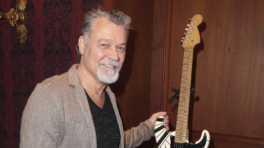 FILE - Eddie Van Halen, left, embraces his son Wolfgang Van Halen after the rock group Van Halen officially announced their North American tour during a news conference in Los Angeles on Aug. 13, 2007. Eddie Van Halen, who had battled cancer, died Tuesday, Oct. 6, 2020. He was 65. (AP Photo/Kevork Djansezian, File)