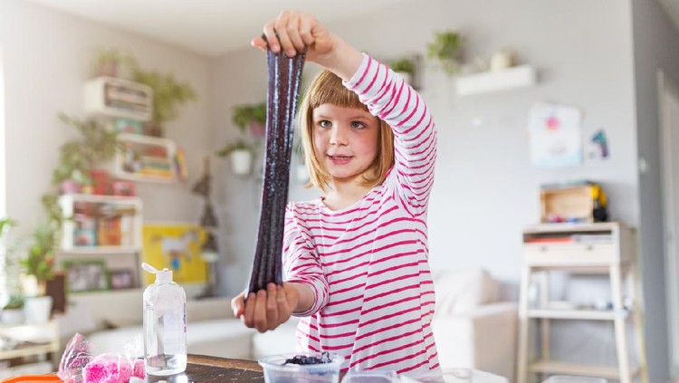 Little girl making homemade slime toy