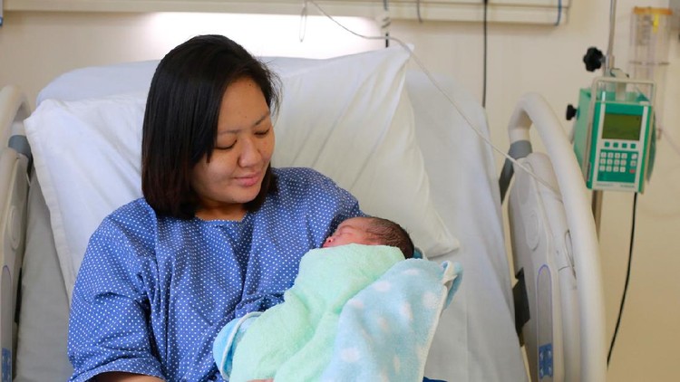 Mother holding her newborn child after labor