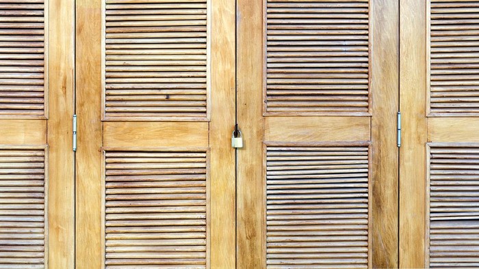 Wooden doors with blinds, element of decor. Interior ventilation.  Wood background, close up.