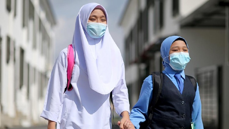 Two Muslim teenage sisters feeling excited to back to school after lockdown order is lifted in Malaysia.
