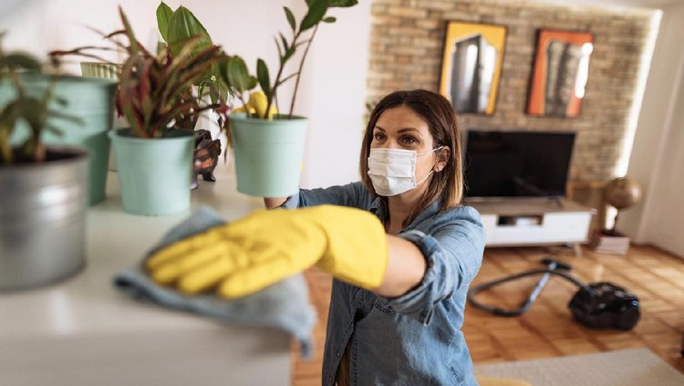 Woman working at home, cleaning the floors, washing the laundry and cleaning up the mess in the closet during quarantine