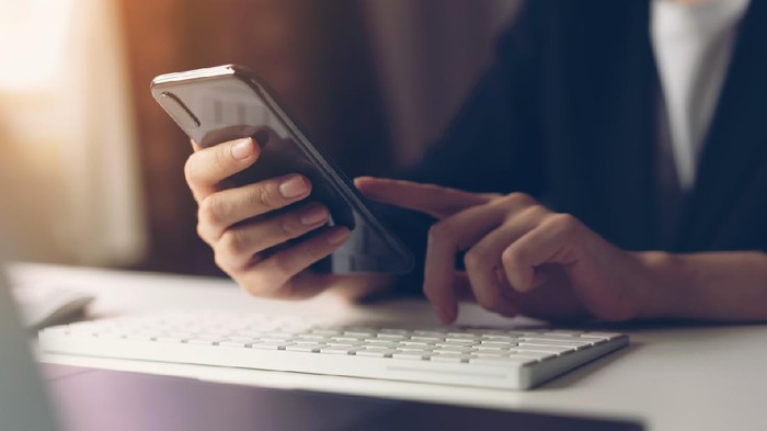 Woman using smartphone. The concept of using the phone is essential in everyday life.