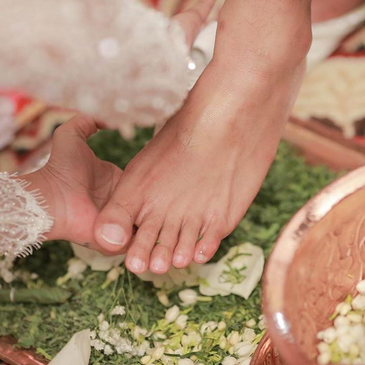 <p>Tata Janeta juga melewati rangkaian proses wijikan atau ranupada, yang artinya membasuh kaki suami. Namun ada yang berkomentar usil nih, Bunda, dengan menyebut kaki Hyun Bin.<em> He-he-he.</em> (Foto: Instagram @tatajaneetaofficial)</p>