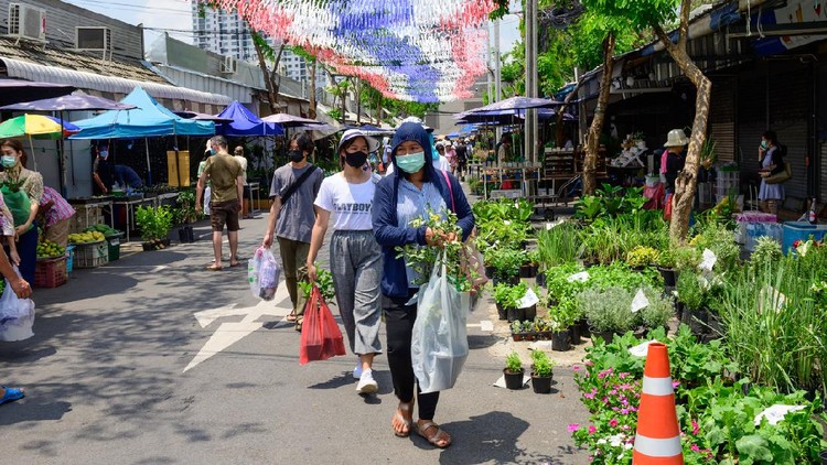 1226125813 Bangkok, Thailand - May 13, 2020 : Crowd of people wearing surgical mask and walking at Chatuchak Plant Market.
