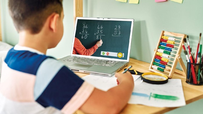 6-7 years cute child learning mathematics from computer.