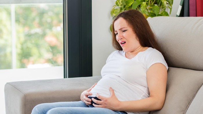 Sick woman with stomach pain due to diarrhea