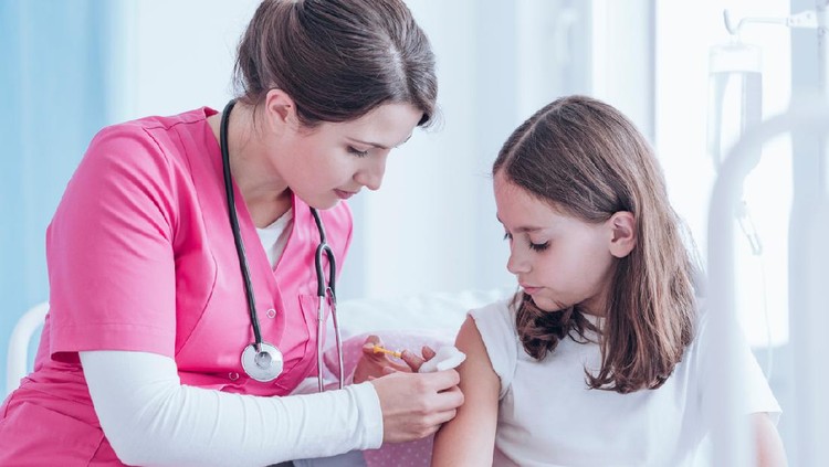Nurse in pink uniform doing an injection to a girl against tuberculosis