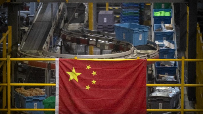 A Chinese flag hangs near an automated parcel handling line at a warehouse for online retailer JD.com in Beijing, Wednesday, Nov. 11, 2020. Chinese consumers are expected to spend tens of billions on everything from fresh food to luxury goods during this year's Singles' Day online shopping festival, as the country recovers from the pandemic. The shopping festival, which is the world's largest and typically begins in November, is an annual extravaganza where China's e-commerce companies offer generous discounts on their platforms. (AP Photo/Mark Schiefelbein)