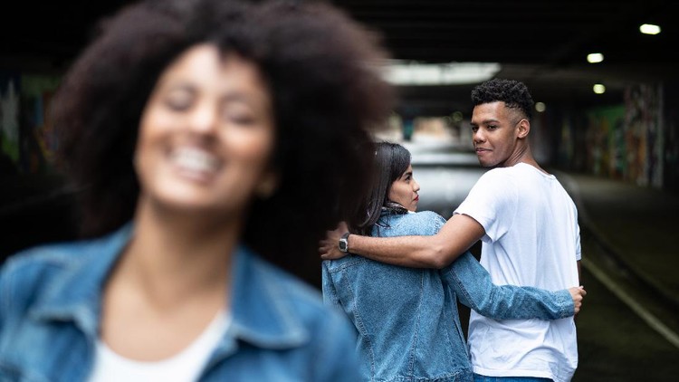 Disloyal boyfriend caught by his angry girlfriend dating with another girl in a restaurant
