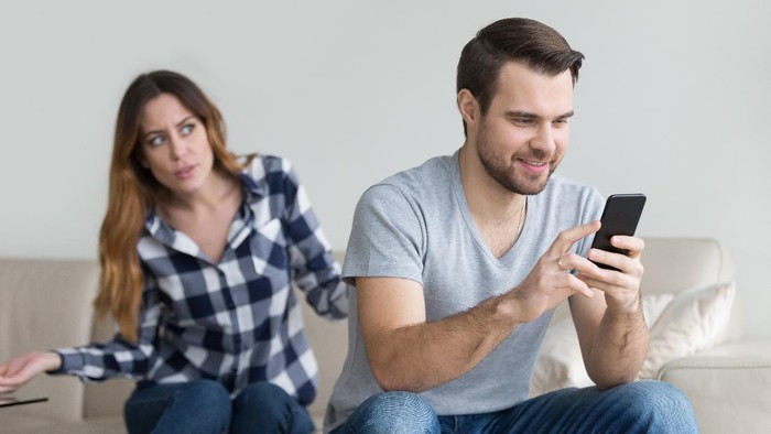 Disloyal boyfriend caught by his angry girlfriend dating with another girl in a restaurant