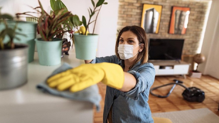 Membersihkan rumah Woman working at home, cleaning the floors, washing the laundry and cleaning up the mess in the closet during quarantine