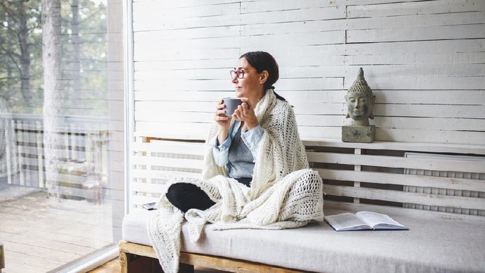 Relaxed serene pretty young woman feel fatigue lounge on comfortable sofa hands behind head rest at home, happy calm lady dream enjoy wellbeing breathing fresh air in cozy home modern living room