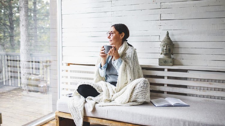 Relaxed serene pretty young woman feel fatigue lounge on comfortable sofa hands behind head rest at home, happy calm lady dream enjoy wellbeing breathing fresh air in cozy home modern living room
