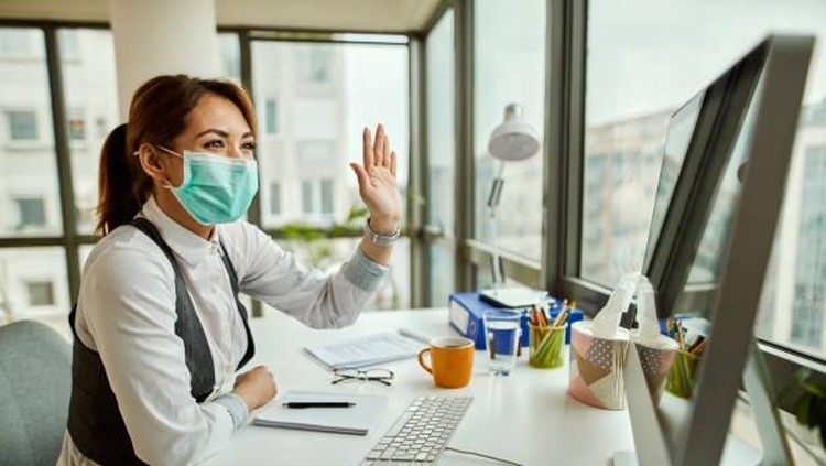 Two people in office passing documents with keeping a distance