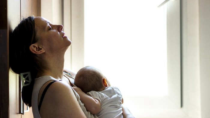 Mother and sleeping newborn and son at hospital