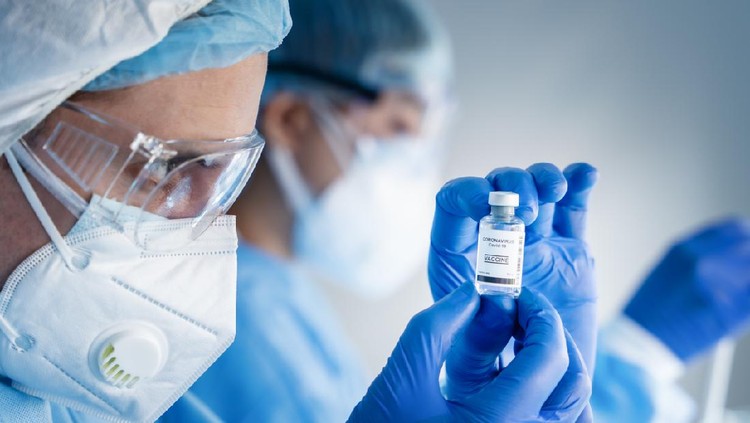 coronavirus covid-19 vaccine bottle in hands of pharmacuetical and vaccine research scientist in laboratory, coronavirus covid-19 vaccine development