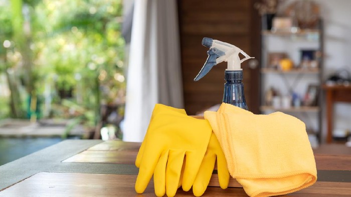 House cleaning products set on wooden table in living room