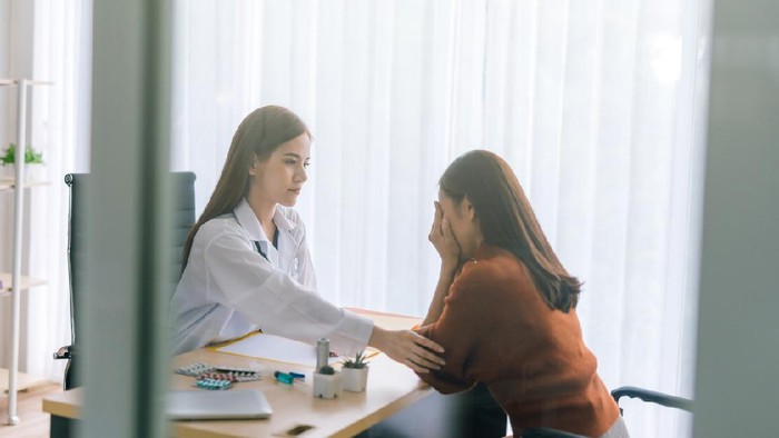 Doctor comforting his depressed patient