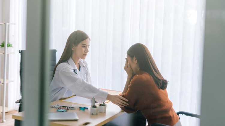 Doctor comforting his depressed patient