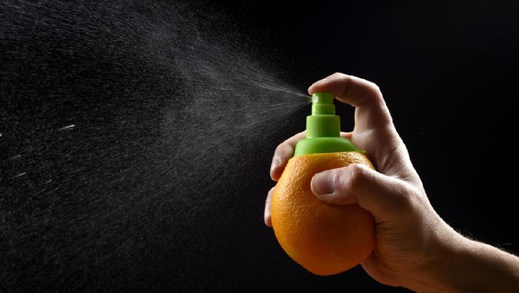 spray Orange spray isolated on black background