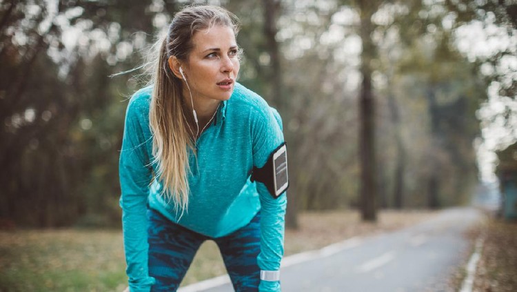 Adult running women exercise outdoor. She is exhausted after hard training, portrait