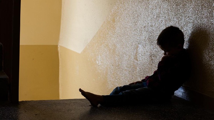 eye of boy through key whole, child abuse concept