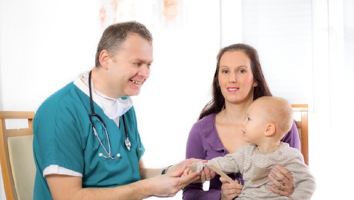 Mom and baby son on examination by a doctor