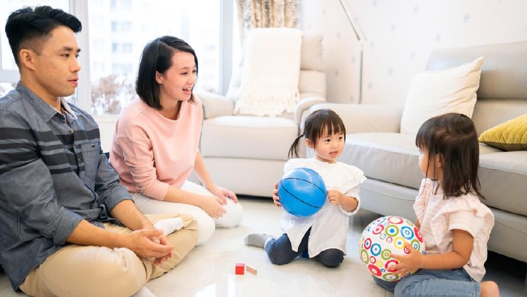 Asian family playing toys at home.
