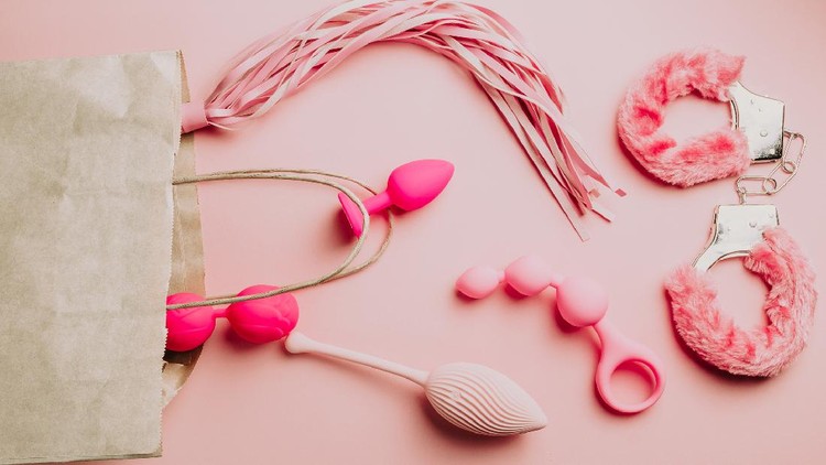 Sex toys and accessories on pink background. Flat lay