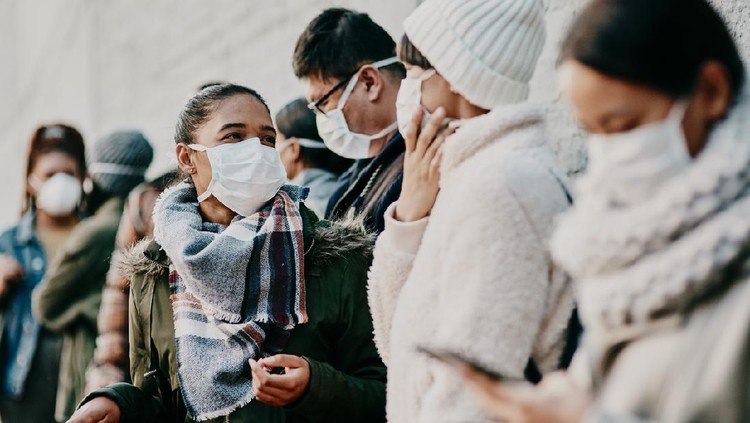 Shot of a young man and woman wearing masks while travelling in a foreign city