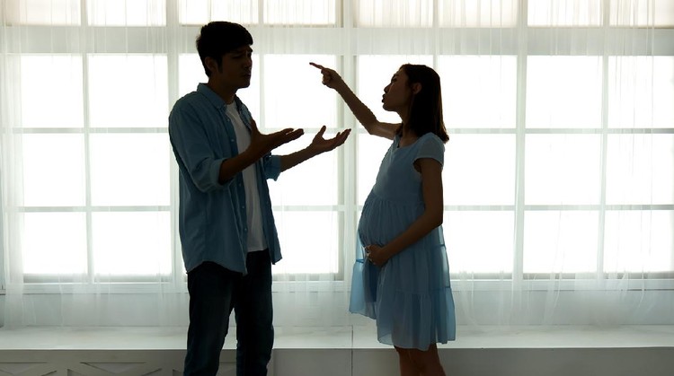 silhouette of pregnant couple arguing and quarreling at home