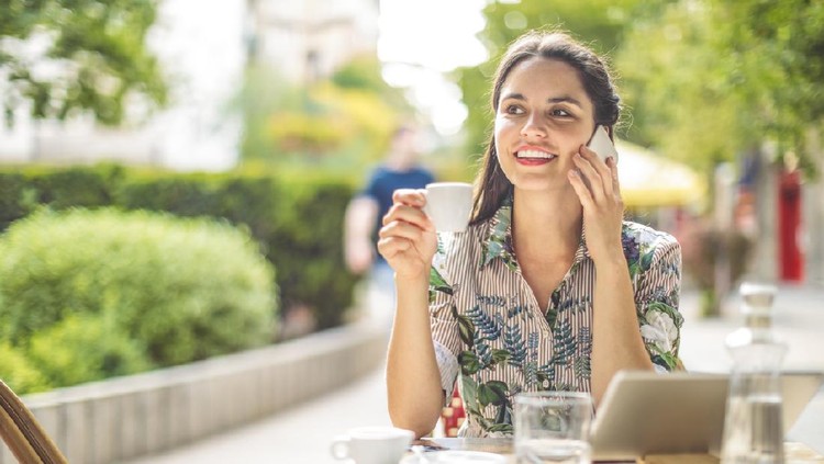 Businesswoman is banking online while out in the city