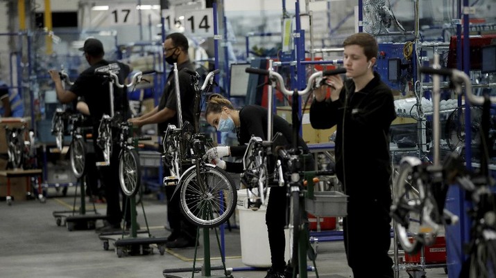 Brompton folding bicycles are assembled by hand at the Brompton factory in west London, Tuesday, Nov. 24, 2020. The team at Brompton Bicycles company thought they were prepared for Britain's Brexit split with Europe, but they face uncertainty about supplies and unexpected new competition from China, all amid a global COVID pandemic.(AP Photo/Matt Dunham)