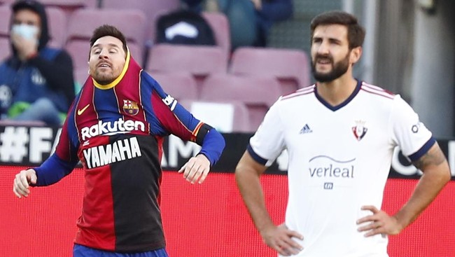 Kapten Lionel Messi melepas baju Barcelona saat merayakan gol yang dicetaknya ke gawang Osasuna, Minggu (29/11).