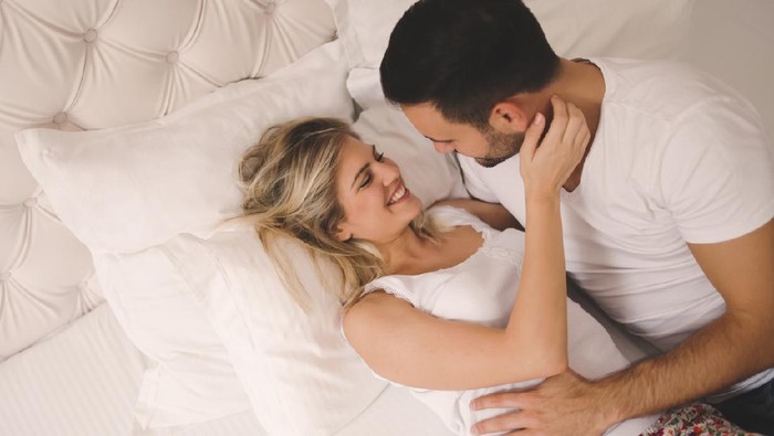 Passionate beautiful couple foreplay in bed