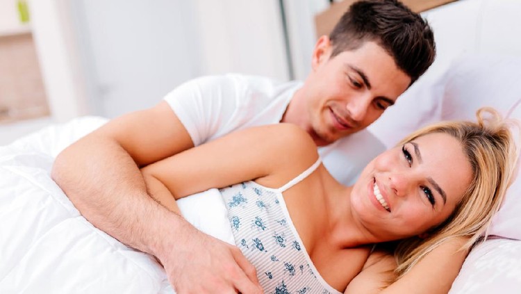 Couple in love  having fun in bed and smiling