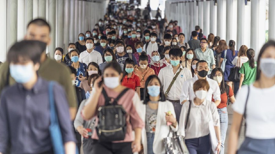 Bangkok, Thailand - Mar 2020 : Crowd of unrecognizable business people wearing surgical mask for prevent coronavirus Outbreak in rush hour working day on March 18, 2020 at Bangkok transportation
