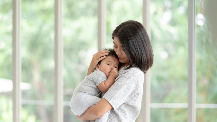 Portrait of young beautiful asian mother with newborn baby in living room. Healthcare and medical love asia woman lifestyle mother's day concept with copy space.