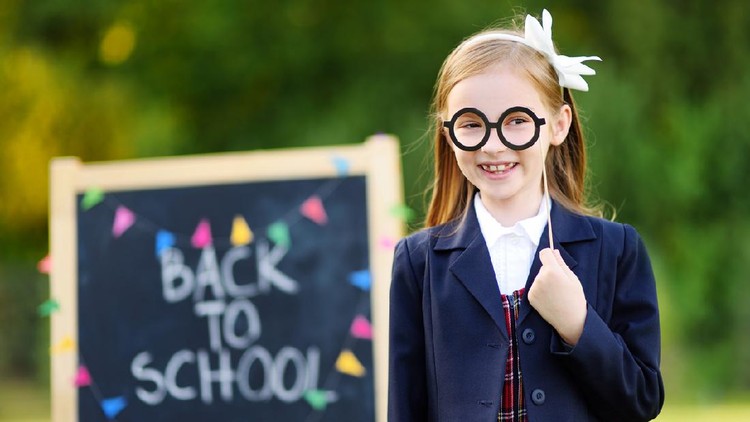 Adorable little girl feeling very excited about going back to school