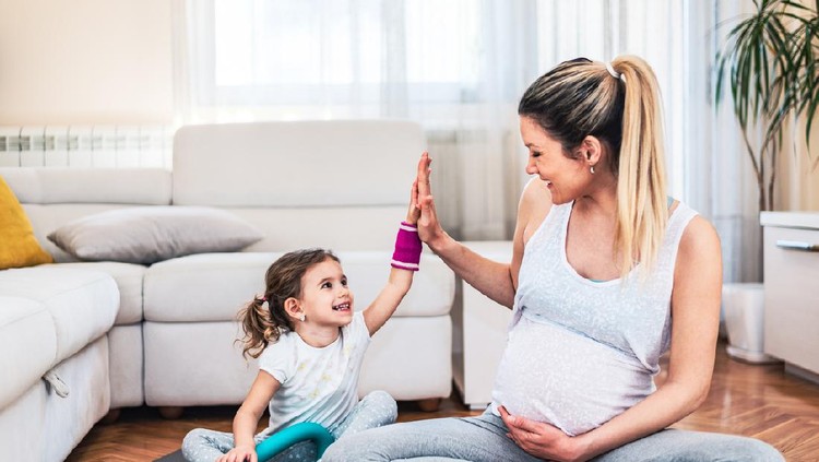 hamil Shot of a young mother practicing yoga with daughter at home. Illness prevention during COVID-19 isolation.