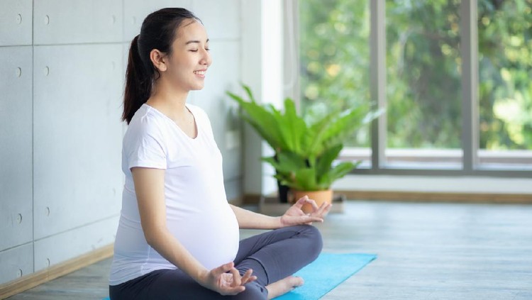 Shot of a young mother practicing yoga with daughter at home. Illness prevention during COVID-19 isolation.