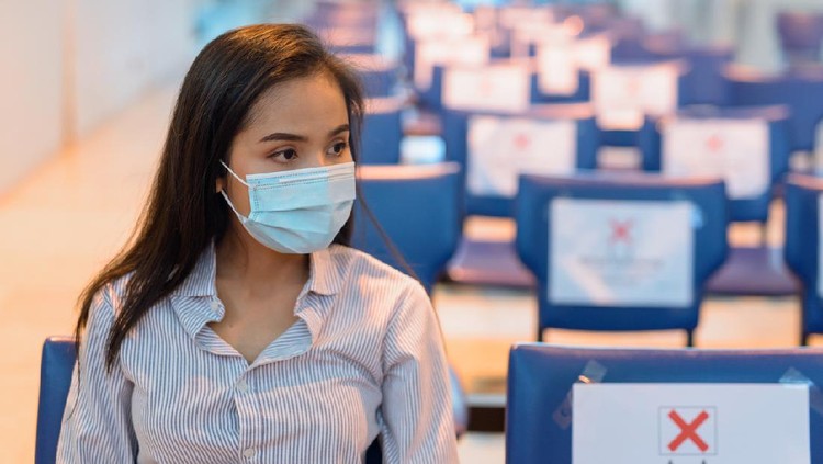 Portrait of young Asian tourist woman with mask for protection from corona virus outbreak social distancing at the airport