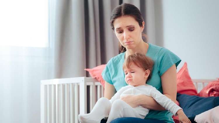 Mother and daughter crying together feeling sadness