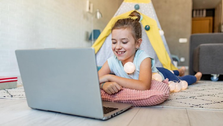 Young girl at home, relaxing on the floor and playing