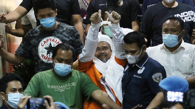 Sidang Rizieq Shihab diwarnai hardikan Munarman sampai dengan putusan hakim yang mengizinkan eks pentolan FPI itu hadir langsung di ruang sidang PN Jaktim.
