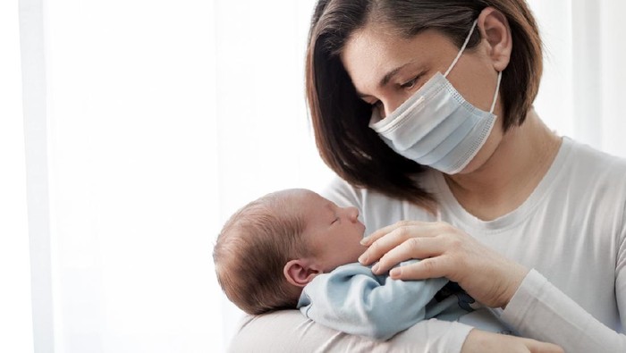 Soft focus of happy mother with newborn baby