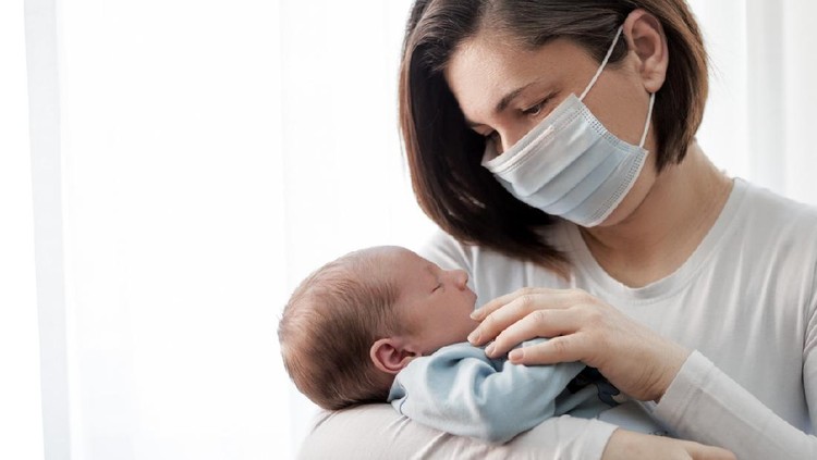 Soft focus of happy mother with newborn baby