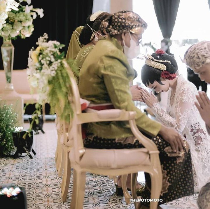 <p>Suasana haru juga terlihat saat prosesi sungkem dengan orang tua masing-masing mempelai, Bunda. (Foto: Instagram @karinadila8921)</p>