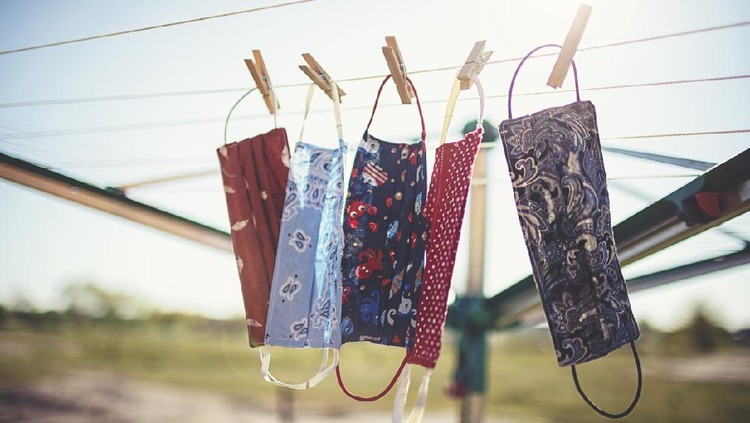 Self-sewn mouth-nose masks against corona viruses hang on the clothesline to dry.
